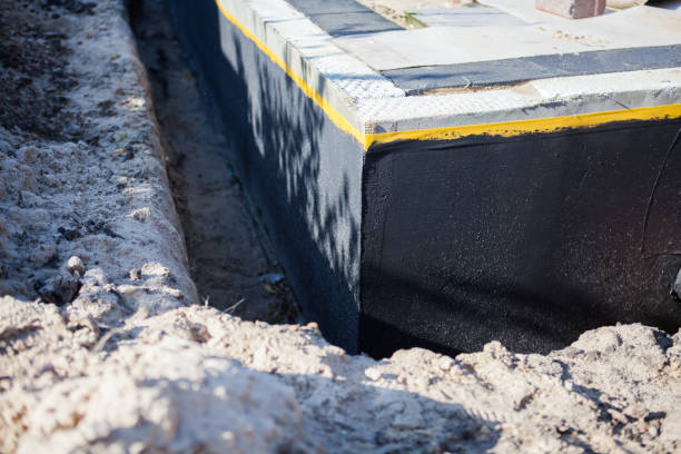 Professional Exterior Waterproofing technician working in Eagle, MI